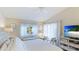 Serene main bedroom featuring hardwood floors, neutral paint, lots of natural light and a beach view TV at 4909 Clubview E Ct, Bradenton, FL 34203