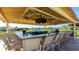 Outdoor bar with a large countertop, seating, and TVs overlooking the community at 4909 Clubview E Ct, Bradenton, FL 34203