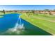 Scenic view of a tranquil pond featuring a fountain and verdant golf course at 4909 Clubview E Ct, Bradenton, FL 34203