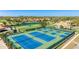 Aerial view of tennis courts, golf course, and a pond, offering recreational opportunities at 4909 Clubview E Ct, Bradenton, FL 34203