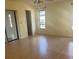 Bright living room with laminate flooring, windows, and access to other rooms at 5125 Palm Aire Dr, Sarasota, FL 34243