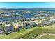 Aerial view of waterfront property with backyard pool and lush landscaping in an idyllic community at 5602 Tidewater Preserve Blvd, Bradenton, FL 34208