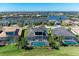Beautifully designed home boasts a screened-in pool, lush landscaping, and modern architecture at 5602 Tidewater Preserve Blvd, Bradenton, FL 34208