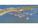 Aerial view of a marina with numerous boats docked and a waterfront restaurant in a scenic location at 5602 Tidewater Preserve Blvd, Bradenton, FL 34208