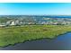 Scenic aerial view of a residential waterfront community with lush green space and open water at 5602 Tidewater Preserve Blvd, Bradenton, FL 34208