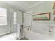 Bright bathroom with a soaking tub, glass-enclosed shower, and decorative accents at 5602 Tidewater Preserve Blvd, Bradenton, FL 34208