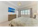 Well-lit bedroom with decorative wall paneling, wood floors, and a mounted flat screen television at 5602 Tidewater Preserve Blvd, Bradenton, FL 34208