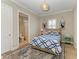 Relaxing bedroom with coastal decor, patterned bedding, and adjoining bathroom at 5602 Tidewater Preserve Blvd, Bradenton, FL 34208