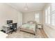 Inviting bedroom with neutral tones, plantation shutters, and a decorative chandelier at 5602 Tidewater Preserve Blvd, Bradenton, FL 34208