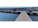 Scenic marina with a wooden walkway and covered boat slips showcasing waterfront living and recreation at 5602 Tidewater Preserve Blvd, Bradenton, FL 34208