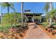 Beautifully landscaped walkway leading to the community clubhouse with palm trees at 5602 Tidewater Preserve Blvd, Bradenton, FL 34208