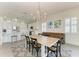 Dining room featuring a large wooden table and seating for six guests, with views of the modern kitchen at 5602 Tidewater Preserve Blvd, Bradenton, FL 34208