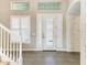 Bright foyer with white accents, an arched brick wall, and a beautiful glass front door at 5602 Tidewater Preserve Blvd, Bradenton, FL 34208