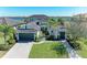 Beautiful single Gathering home with lush landscaping, two-car garage, and brick driveway at 5602 Tidewater Preserve Blvd, Bradenton, FL 34208