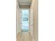 Hallway view leading to the bathroom, showcasing the home's open layout at 5602 Tidewater Preserve Blvd, Bradenton, FL 34208