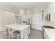 Open kitchen featuring a large island with seating, white cabinets, and stainless steel appliances at 5602 Tidewater Preserve Blvd, Bradenton, FL 34208