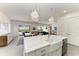 Spacious kitchen with a large island, stainless steel sink, and an open layout to the dining and living areas at 5602 Tidewater Preserve Blvd, Bradenton, FL 34208