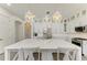 Bright kitchen with oversized island, lantern lighting, stainless steel appliances, and white cabinets at 5602 Tidewater Preserve Blvd, Bradenton, FL 34208