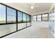 Enclosed lanai featuring tile flooring and large windows providing serene water views at 5602 Tidewater Preserve Blvd, Bradenton, FL 34208