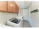 Functional laundry room with a modern washer/dryer, ample cabinetry, and sink at 5602 Tidewater Preserve Blvd, Bradenton, FL 34208