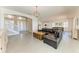Open-concept living room with a large sectional and stairway to the second floor, along with views of the dining area at 5602 Tidewater Preserve Blvd, Bradenton, FL 34208