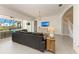 Spacious living room with views of the pool area through sliding glass doors and stairway to second floor at 5602 Tidewater Preserve Blvd, Bradenton, FL 34208