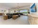 Bright living room featuring a large leather sectional and sliding glass doors to the outdoor pool area at 5602 Tidewater Preserve Blvd, Bradenton, FL 34208