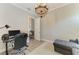Office area with a desk, chair, and a decorative chandelier at 5602 Tidewater Preserve Blvd, Bradenton, FL 34208