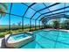 Screened-in pool area with a private jacuzzi tub overlooking the yard and scenery at 5602 Tidewater Preserve Blvd, Bradenton, FL 34208