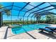 A refreshing swimming pool and integrated hot tub are surrounded by comfortable lounge chairs and lush tropical landscaping at 5602 Tidewater Preserve Blvd, Bradenton, FL 34208