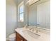 Elegant powder room boasts a marble countertop, wood vanity, and modern fixtures at 5602 Tidewater Preserve Blvd, Bradenton, FL 34208