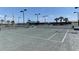 A sunny, fenced-in tennis court with a covered bench overlooks a scenic pond at this residential community at 5602 Tidewater Preserve Blvd, Bradenton, FL 34208