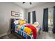 Nautical bedroom featuring brightly colored quilts, wood floors, and natural light at 5715 Sea Trout Pl, Apollo Beach, FL 33572