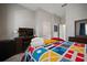 This bedroom features a colorful nautical themed quilt, TV, and comfortable furnishings at 5715 Sea Trout Pl, Apollo Beach, FL 33572