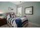 Relaxing bedroom featuring a whale art piece, nautical decor, and comfortable furnishings at 5715 Sea Trout Pl, Apollo Beach, FL 33572