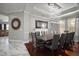 Dining room with a long dark wood table, seating for twelve, and modern decor at 5715 Sea Trout Pl, Apollo Beach, FL 33572