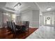 Elegant dining room featuring a large table, unique chandelier, and hardwood floors at 5715 Sea Trout Pl, Apollo Beach, FL 33572