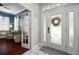 Bright foyer with a decorative front door, marble flooring, and view into the front office at 5715 Sea Trout Pl, Apollo Beach, FL 33572