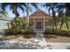 Charming, colorful one-story home with front porch, well maintained landscaping, and mature palm trees at 5715 Sea Trout Pl, Apollo Beach, FL 33572