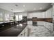 Well-lit kitchen featuring white cabinets, dark countertops, and stainless steel appliances, perfect for modern cooking at 5715 Sea Trout Pl, Apollo Beach, FL 33572