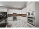 Bright kitchen featuring marble floors, stainless steel appliances, and white cabinetry for a modern aesthetic at 5715 Sea Trout Pl, Apollo Beach, FL 33572