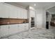 Well-lit kitchen with sleek stainless-steel appliances, dark countertops, and ample cabinet space for storage at 5715 Sea Trout Pl, Apollo Beach, FL 33572