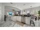 Open-concept kitchen featuring a spacious island, stainless steel appliances, and seamless flow to the dining area at 5715 Sea Trout Pl, Apollo Beach, FL 33572