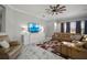 Cozy living room featuring a comfortable sectional, colorful rug, and ample natural light for a welcoming atmosphere at 5715 Sea Trout Pl, Apollo Beach, FL 33572