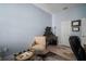 Well-lit home office with dual monitors, wood barrel table, and comfortable seating at 5715 Sea Trout Pl, Apollo Beach, FL 33572
