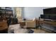 Home office with dual monitors, mini-fridge, wood barrel table, and comfortable seating at 5715 Sea Trout Pl, Apollo Beach, FL 33572