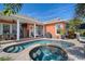 Stunning pool and spa with a covered patio, outdoor kitchen area, and manicured landscaping at 5715 Sea Trout Pl, Apollo Beach, FL 33572