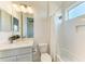 Bright bathroom features a shower/tub combo, white subway tile, and a vanity with a mirror at 5822 Title Row Dr, Bradenton, FL 34210