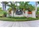 Elegant entrance sign for Legends Bay, framed by lush greenery and stately columns with tile accents at 5822 Title Row Dr, Bradenton, FL 34210