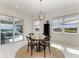 Cozy dining area with round table set for four, view of the pool and lake at 5822 Title Row Dr, Bradenton, FL 34210